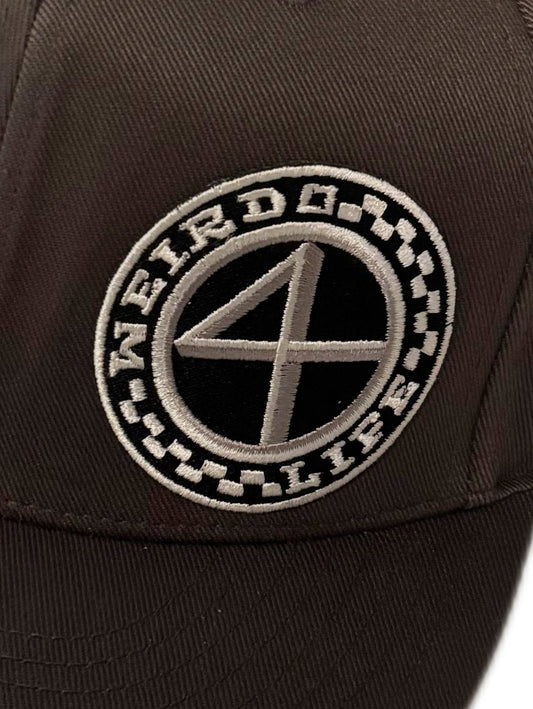 Close-up of embroidered Weirdo 4 Life logo patch on a dark gray flat brim hat