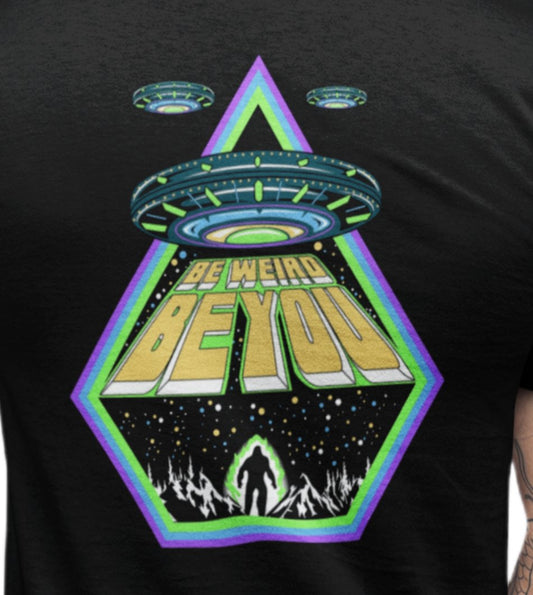 Close-up of UFO, alien and Bigfoot-inspired artwork on a Weirdo 4 Life T-shirt